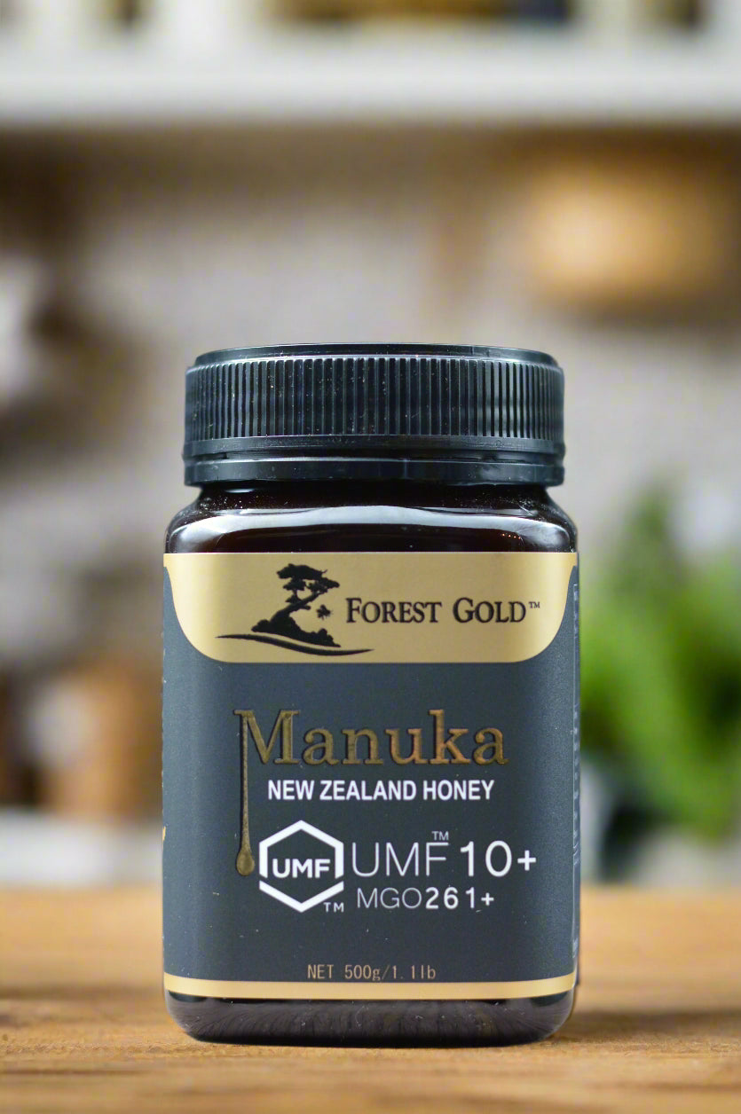 Manuka honey bottle with UMF 10+ rating on a gray background