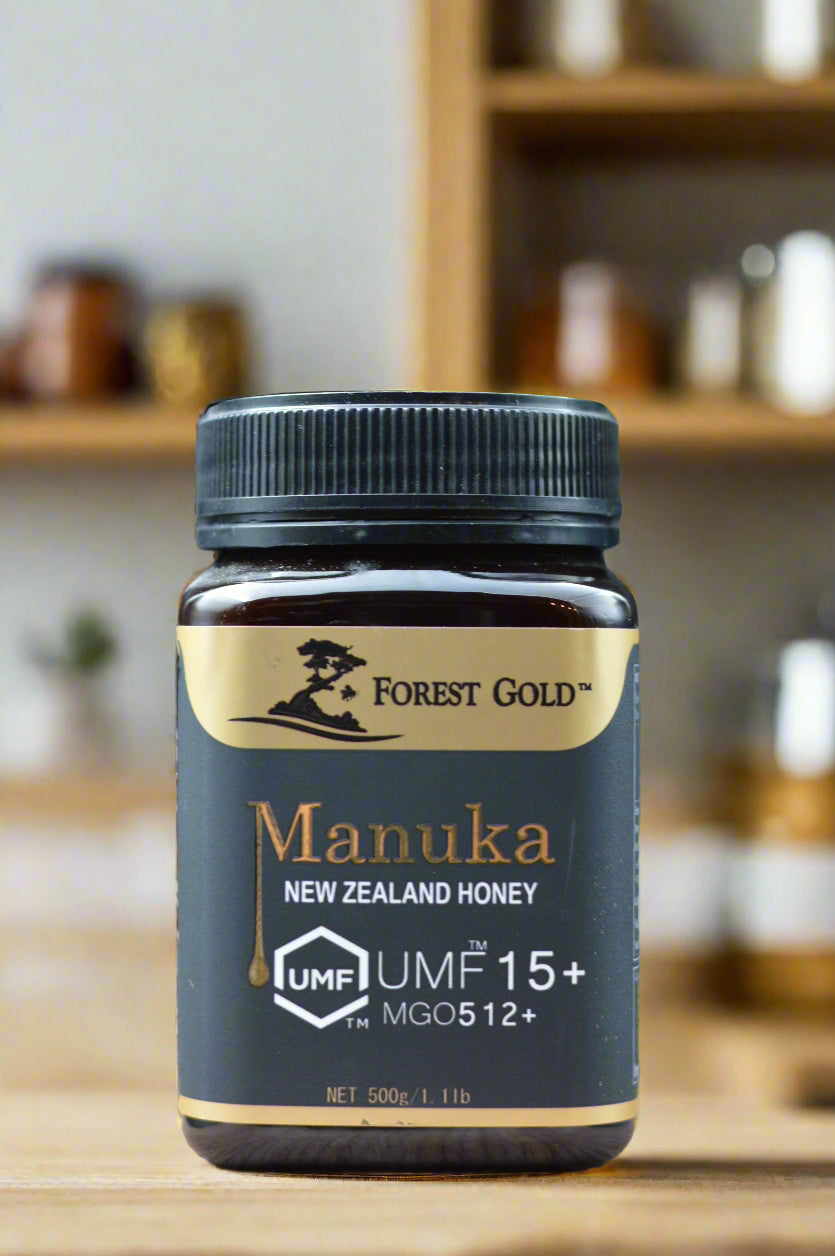 Manuka honey jar with Forest Gold branding on a wooden surface