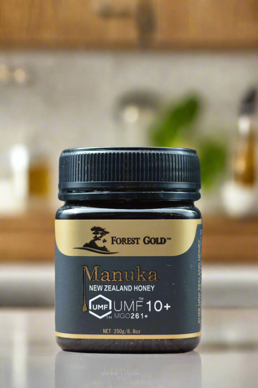 Manuka honey container with 'Forest Gold' branding on a gray background